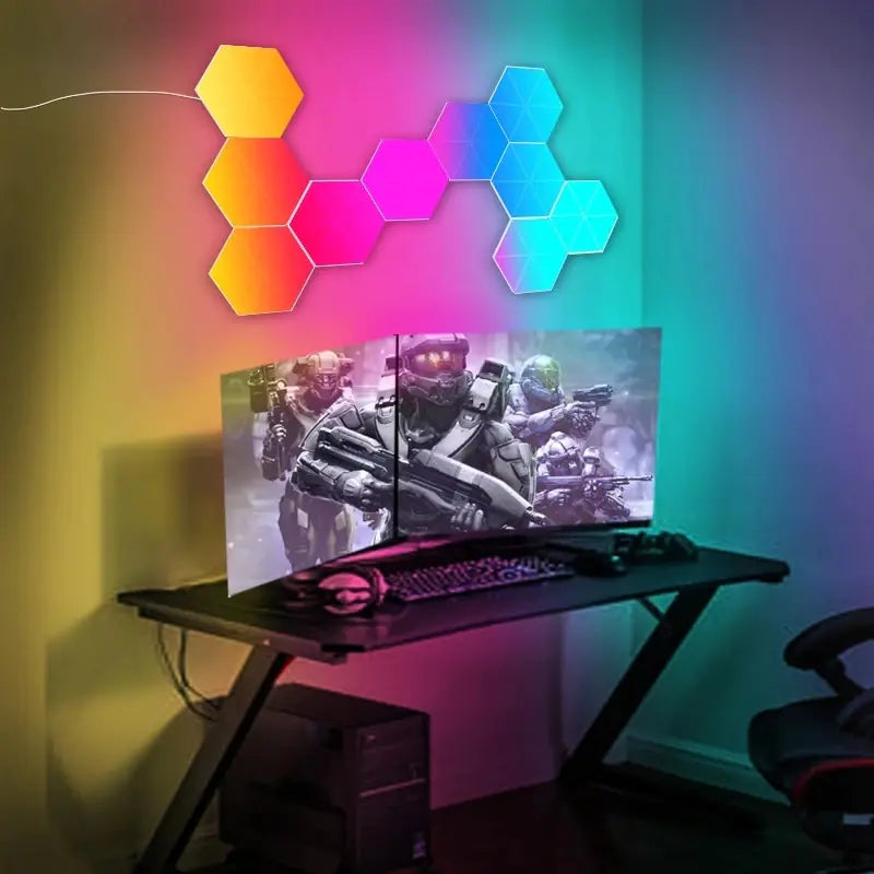 Hexagon LED wall light panels glowing above a gaming desk